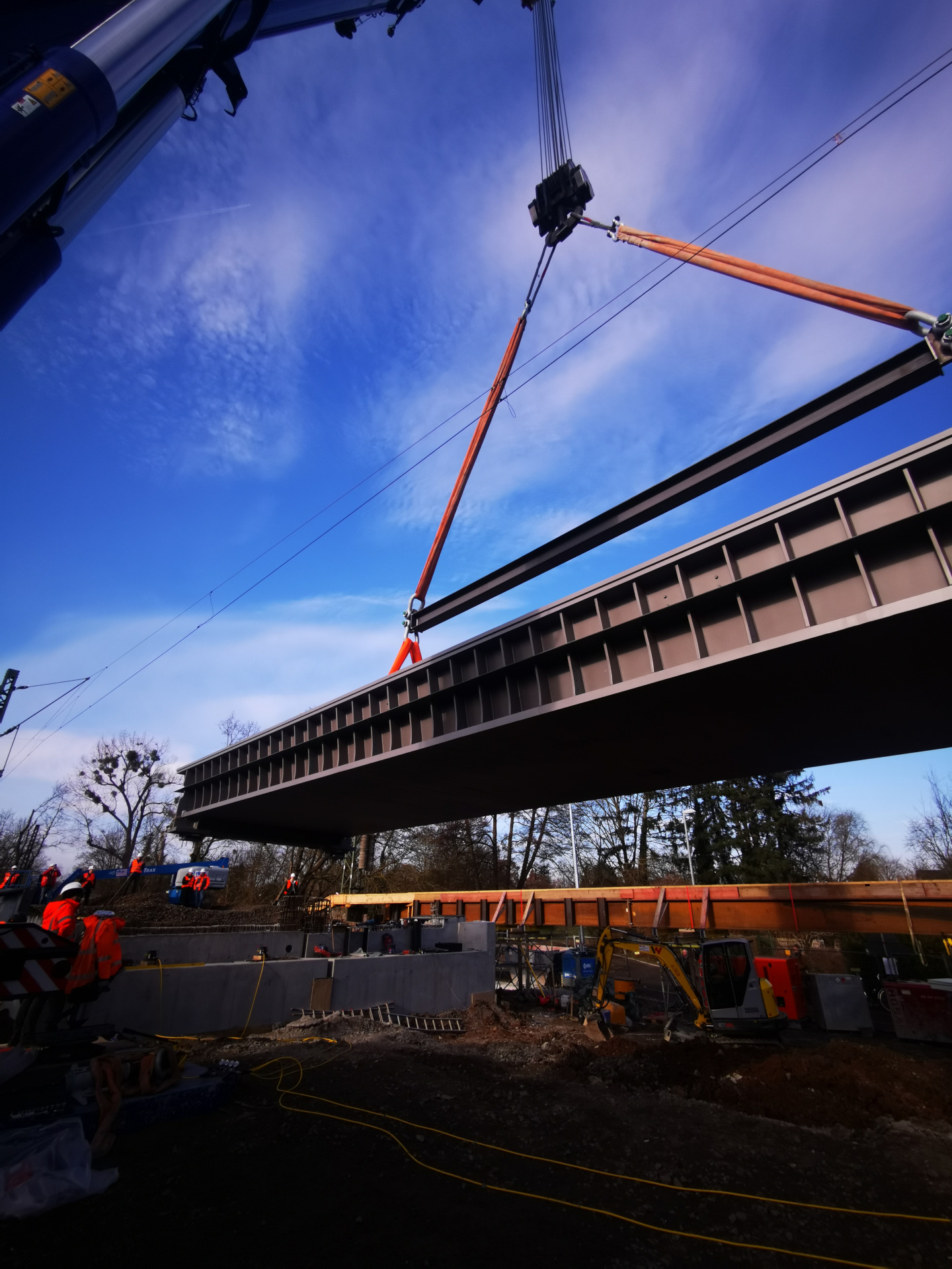 Bauteil der neuen Eisenbahnüberführung Salisbach hängt am Kran